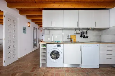 a kitchen with a washer and a washing machine at Casa Joia by Seewest in Bensafrim