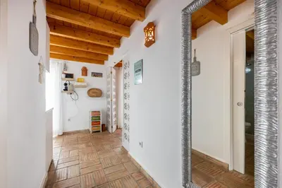 a hallway with white walls and a wooden ceiling at Casa Joia by Seewest in Bensafrim