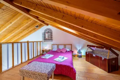 a bedroom with a large bed in a attic at Casa Joia by Seewest in Bensafrim