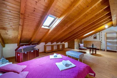 a bedroom with a large pink bed in a room at Casa Joia by Seewest in Bensafrim
