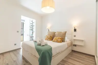a bedroom with a white bed with pillows at Cosy Central by Atlantic Holiday in Funchal