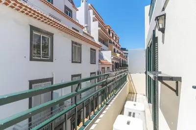 a white bedroom with a bed and a window at Cosy Central by Atlantic Holiday in Funchal