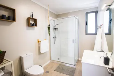 a bathroom with a shower and a toilet at Villa Sundowner in Prazeres