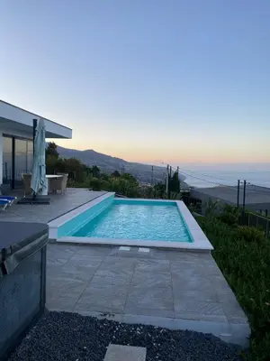 a swimming pool in the backyard of a house at Villa Sundowner in Prazeres
