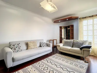 a living room with two white couches and a rug at Milagres Apartment by Atlantic Holiday in Machico