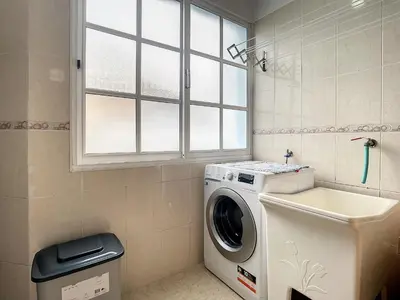 a washing machine in a bathroom with a window at Milagres Apartment by Atlantic Holiday in Machico