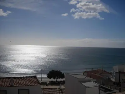 a view of the ocean from a building at apartment with amazing sea view in Burgau