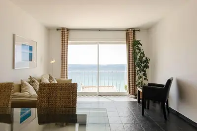 a living room with a couch and a view of the ocean at apartment with amazing sea view in Burgau