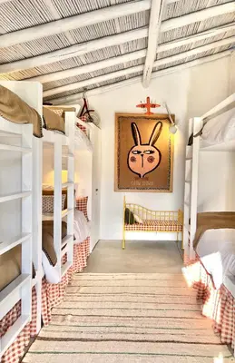 a kids room with bunk beds and a cross on the wall at Casa da Oliveira - Monte Branco in Aljezur