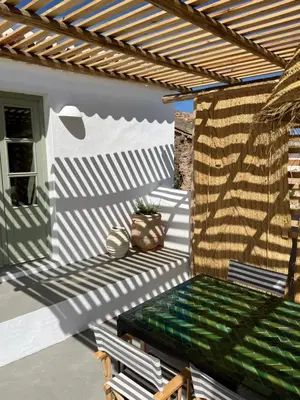 a pergola with a green bench on a patio at Casa da Oliveira - Monte Branco in Aljezur
