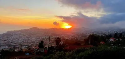 a person standing on a hill watching the sunset at Casa da Conceição - Bay View Spot in Funchal