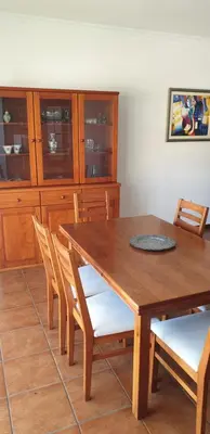 a wooden dining room table with chairs and cabinets at Casa da Conceição - Bay View Spot in Funchal