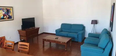 a living room with two blue chairs and a coffee table at Casa da Conceição - Bay View Spot in Funchal