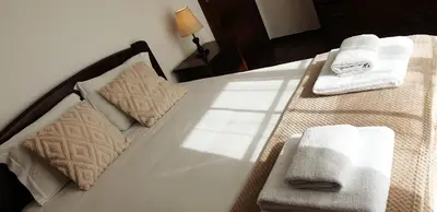 a white bed with towels on top of it at Casa da Conceição - Bay View Spot in Funchal