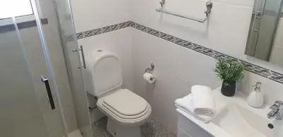 a white bathroom with a toilet and a sink at Casa da Conceição - Bay View Spot in Funchal