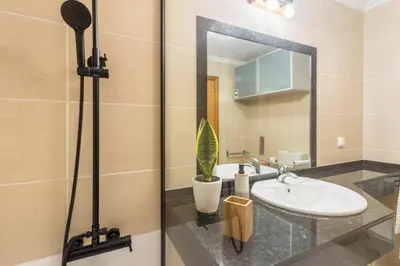 a bathroom with a sink and a mirror at Madeira Sea View Apartment in Caniço