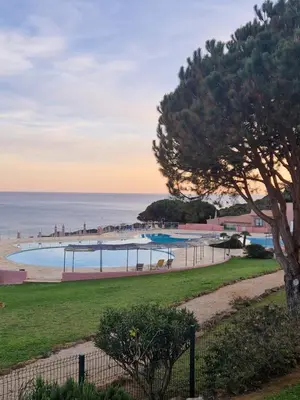 a view of a swimming pool and the ocean at Lighthouse Apartment in Luz