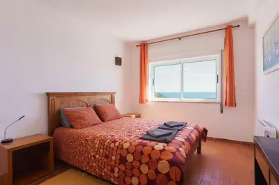 a bedroom with two beds and a dresser at apartment with breathtaking view in Burgau