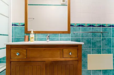 a bathroom with a sink and a mirror at cozy sunny peaceful flat with swimming pool in Burgau