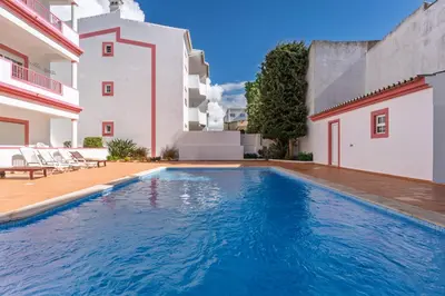 a swimming pool in the backyard of a house at cozy sunny peaceful flat with swimming pool in Burgau