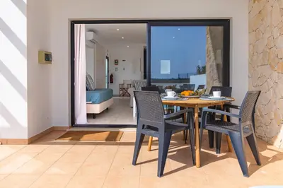 a dining room with a table and chairs at Villa Alcione in Sagres