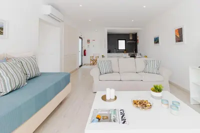a living room with a couch and a table at Villa Alcione in Sagres