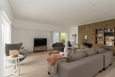 a living room with a couch and a fireplace at Dune Beach CoLiving in Porto Santo