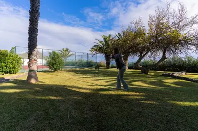 a person playing with a frisbee in a park at Dune Beach CoLiving in Porto Santo