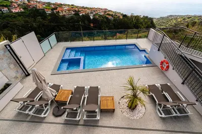 a balcony with chairs and a swimming pool at Casa Bella Vista - Calheta in Arco da Calheta