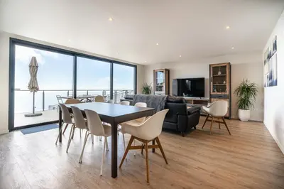 a dining room and living room with a table and chairs at Casa Bella Vista - Calheta in Arco da Calheta