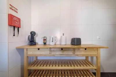 a wooden table in a room with a telephone at Garajau Ocean View in Caniço