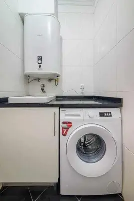 a washer and dryer in a small kitchen at Garajau Ocean View in Caniço