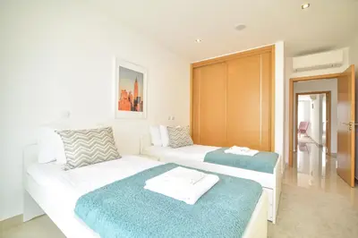 a bedroom with two beds with blue and white at WIOLA SeaView Apartment by MOJE Holiday in Lagos