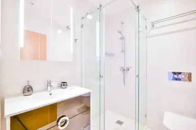 a bathroom with a sink and a shower at WIOLA SeaView Apartment by MOJE Holiday in Lagos