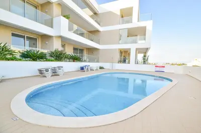a large swimming pool in the middle of a building at WIOLA SeaView Apartment by MOJE Holiday in Lagos