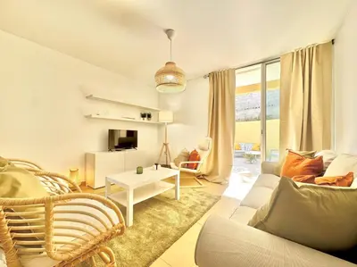 a living room with a couch and a table at Maria da Vinha Porto Santo Beach House in Porto Santo