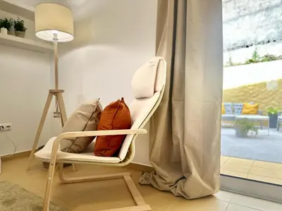a chair with a pillow in a room with a window at Maria da Vinha Porto Santo Beach House in Porto Santo