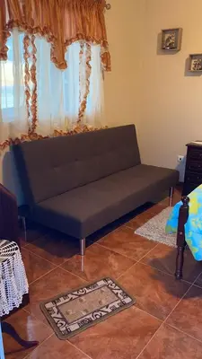 a couch in a living room with a window at Slice of ponta do sol Room 1 in Ponta do Sol