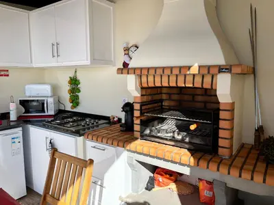 a kitchen with a brick oven in the corner at Slice of ponta do sol Room 1 in Ponta do Sol