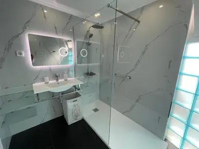 a white bathroom with a sink and a shower at Villa Madeira island in Caniço