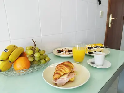 a table topped with plates of food and fruit at MCStylo - Varandas Falésia in Caniço