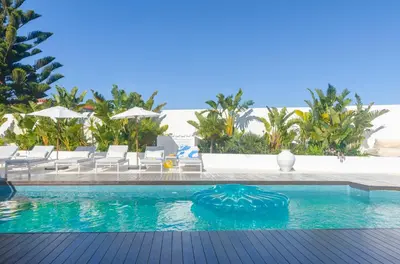 a pool at a resort with chairs and umbrellas at Villa Sound of the Sea by Portugal Collection in Aljezur