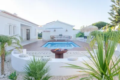 a backyard with a swimming pool and a house at Villa Sound of the Sea by Portugal Collection in Aljezur
