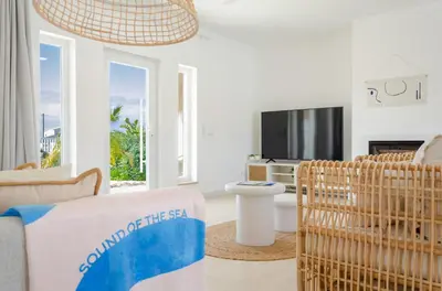 a living room with a couch and a tv at Villa Sound of the Sea by Portugal Collection in Aljezur