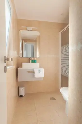 a bathroom with a sink and a toilet and a mirror at Villa Sound of the Sea by Portugal Collection in Aljezur