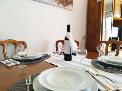 a bottle of wine sitting on a table with glasses at MCStylo-Ocean View in Caniço