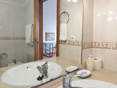 a bathroom with a sink and a mirror at MCStylo-Ocean View in Caniço