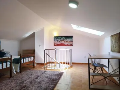 a living room with a table and a dining room at MCStylo-Ocean View in Caniço
