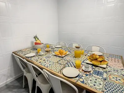 a table with plates and orange juice on it at Casa Safira by LovelyStay in Paul do Mar