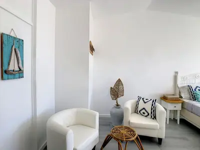 a living room with two chairs and a bed at Casa Safira by LovelyStay in Paul do Mar